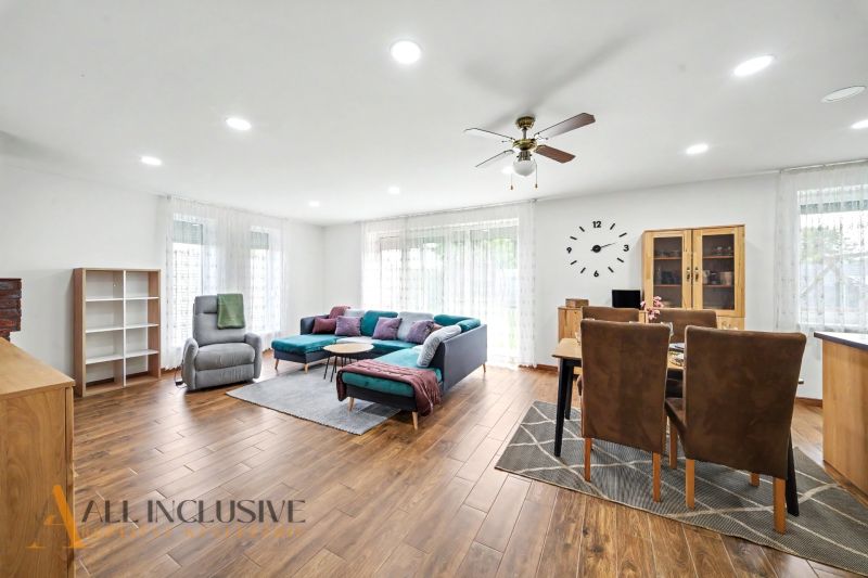 Living room in a family house with comfortable seating and a wooden decor floor.