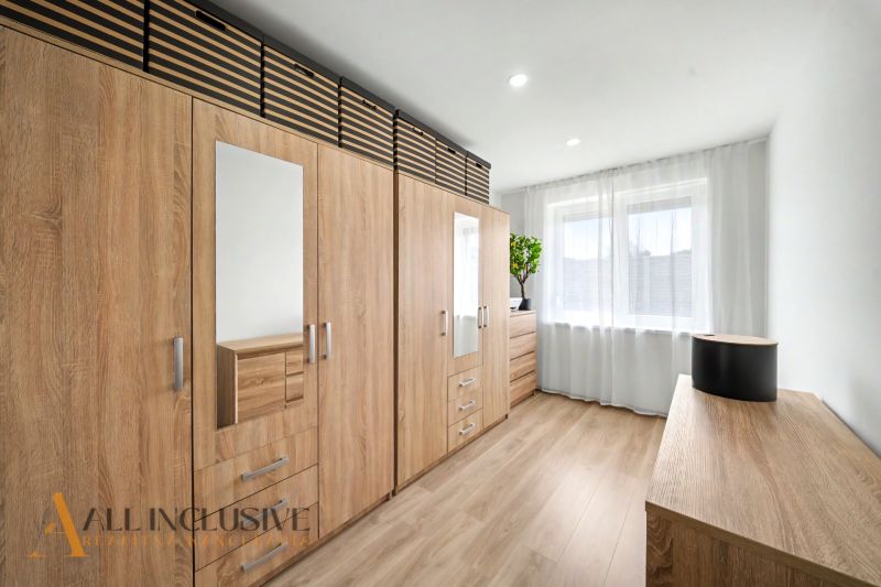 Interior of a family house with a large wardrobe and a floor with a wooden decor.