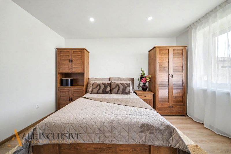 A bedroom in a family house with wooden furniture and a floor with a wooden decor.