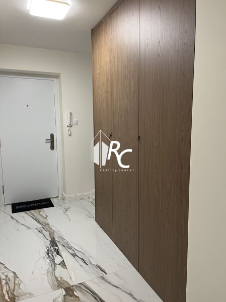Entrance hallway of a 2-room apartment with tiles and a built-in wardrobe.