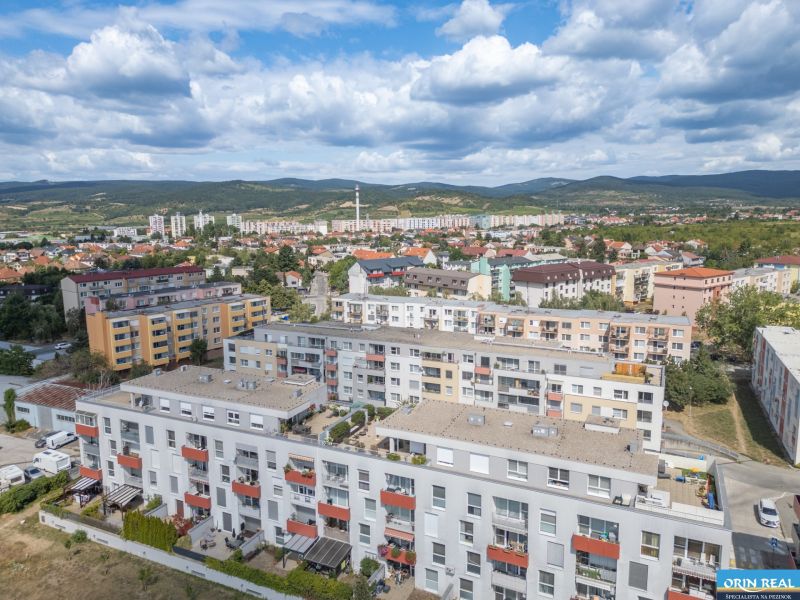Pezinok, Silvánová: View of multi-storey buildings with hills in the background.