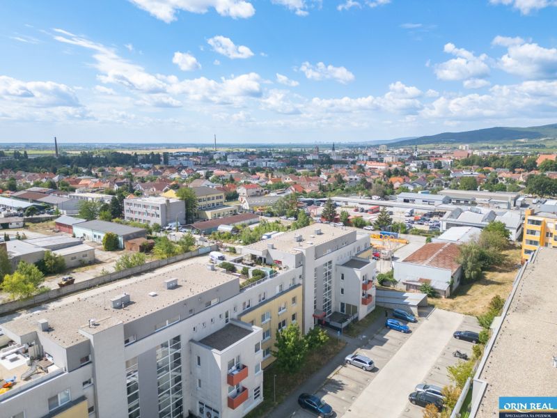 Aerial view of a 1-bedroom apartment in Pezinok, Silvánová, surrounded by residential buildings and greenery.