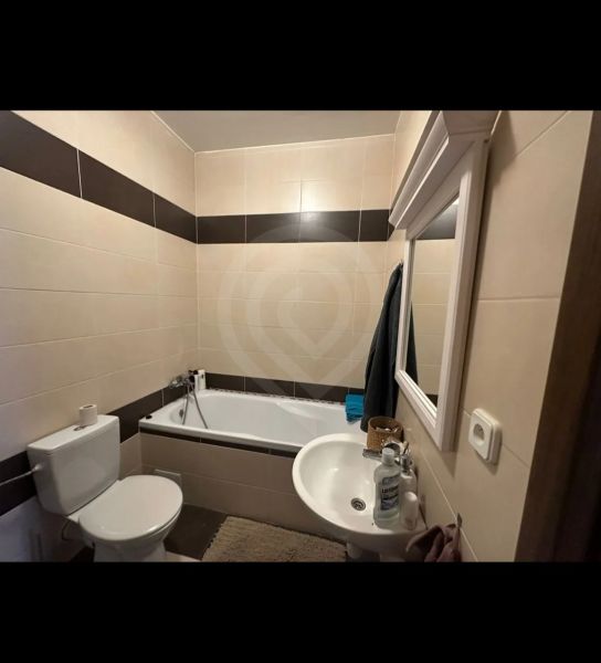 Bathroom in a 2-room apartment with a bathtub, sink, and toilet.