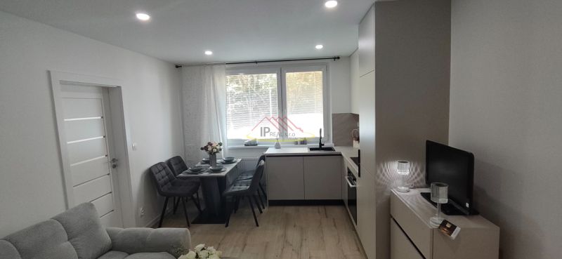 Living room with integrated kitchen and dining set, 3-room apartment, floor with wood decor.