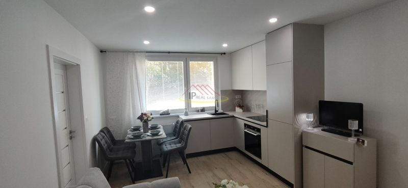 A kitchen with a dining table in a 3-room apartment, floor with wood decor.