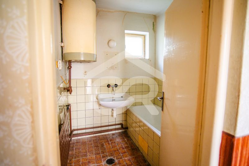 Bathroom in a family house with a boiler and a shower tray.