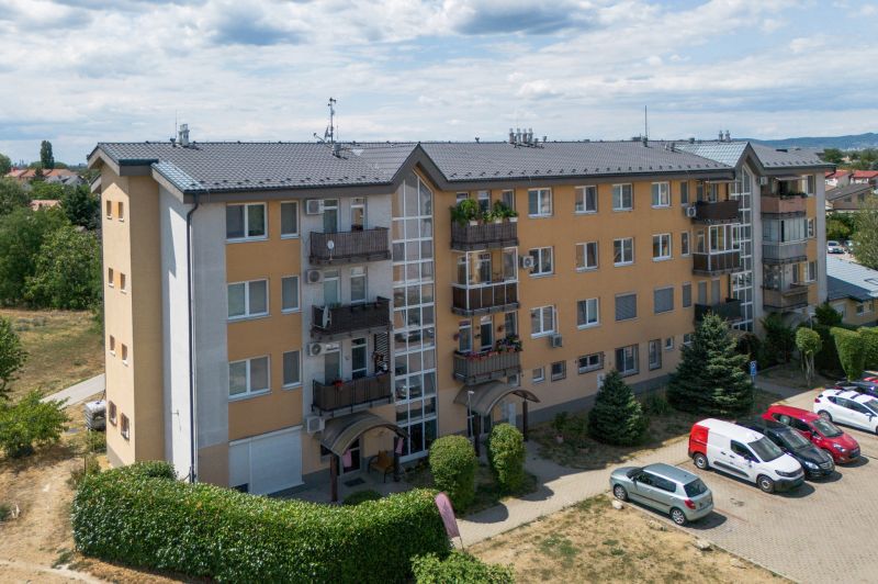 Apartment building on M.R. Štefánik Street in Most pri Bratislave, parking lot, greenery.
