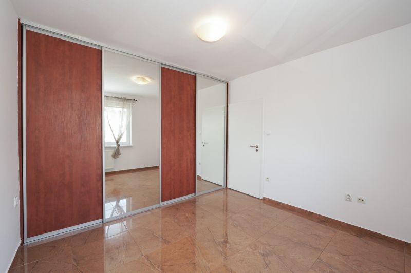 A wardrobe with mirrors in a 3-room apartment, a floor with a wooden decor.