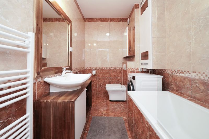 A bathroom in a 3-room apartment with a built-in bathtub, sink, and washing machine.