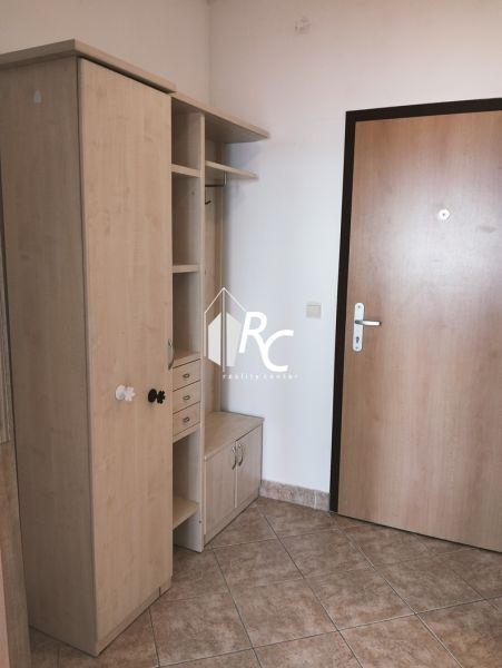 Entrance hallway with cabinets and a coat rack in a 2-room apartment.