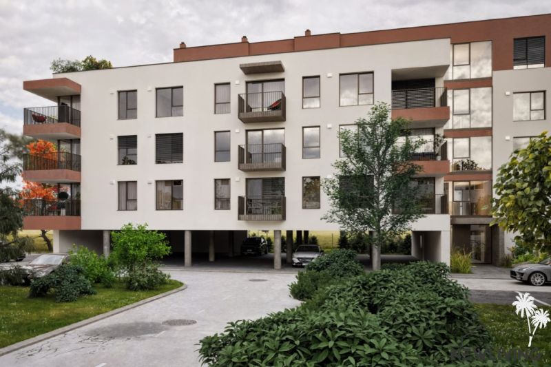 An apartment building on Brigádnická Street in Piešťany with greenery and parking.