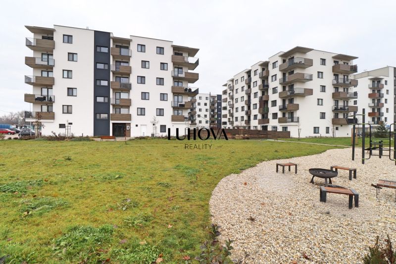 Residential complex on Višňová Street in Bytča with greenery and a children's playground.