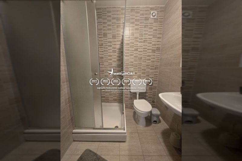 Bathroom with toilet and shower in a 2-room apartment.