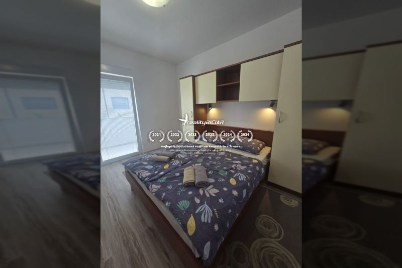 Bedroom with a double bed in a 2-room apartment, floor with wood decor.