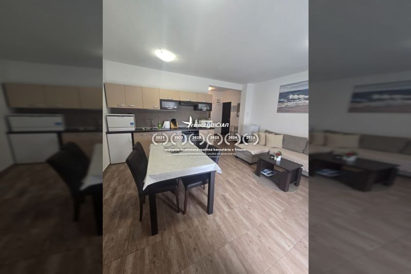 Interior of a 2-room apartment with a kitchenette and flooring with a wood decor.