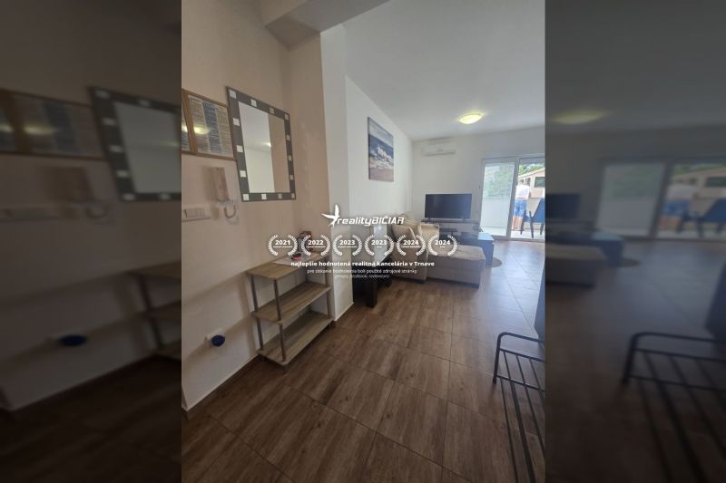 Bright living space in a two-room apartment with a wooden decor floor.