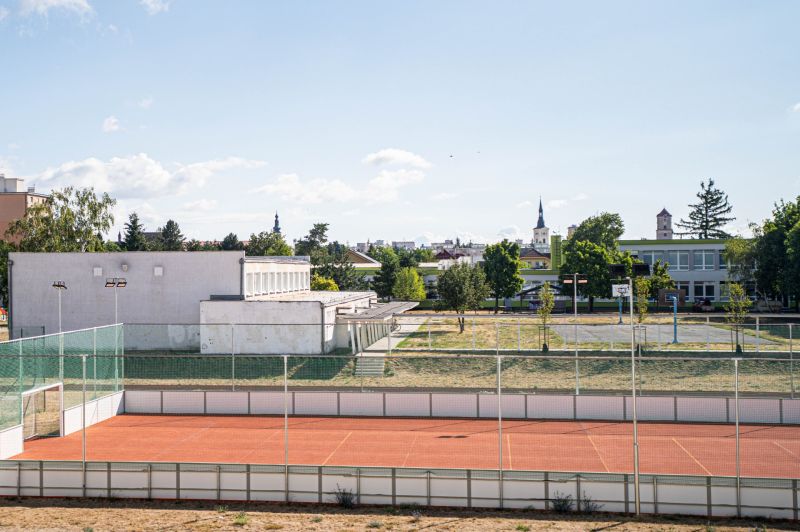 Exterior in Pezinok on 1. mája Street with a playground and buildings in the background.