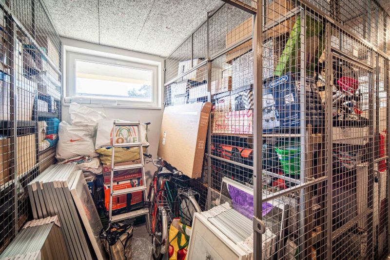 A storage space with network shelves and a lot of stored items in a 2-room apartment.