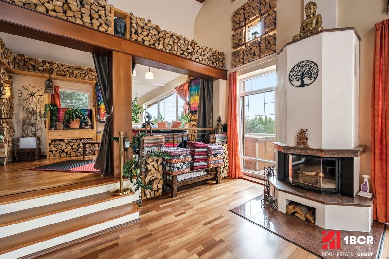 Interior of a family house with wooden decor, a fireplace, and natural elements.