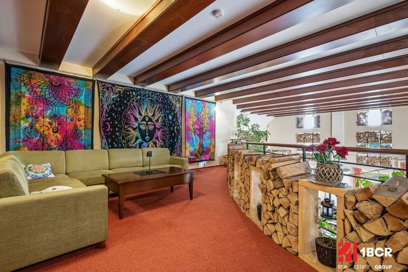 Living space in a family house with colorful tapestries and a comfortable seating area.