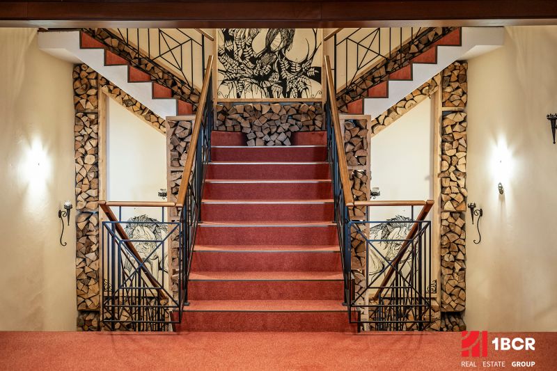 A staircase with carpet, wooden decorations, artistic walls in a family house.