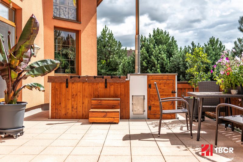 The terrace of a family house in Veľká Lomnica with wooden elements and garden furniture.