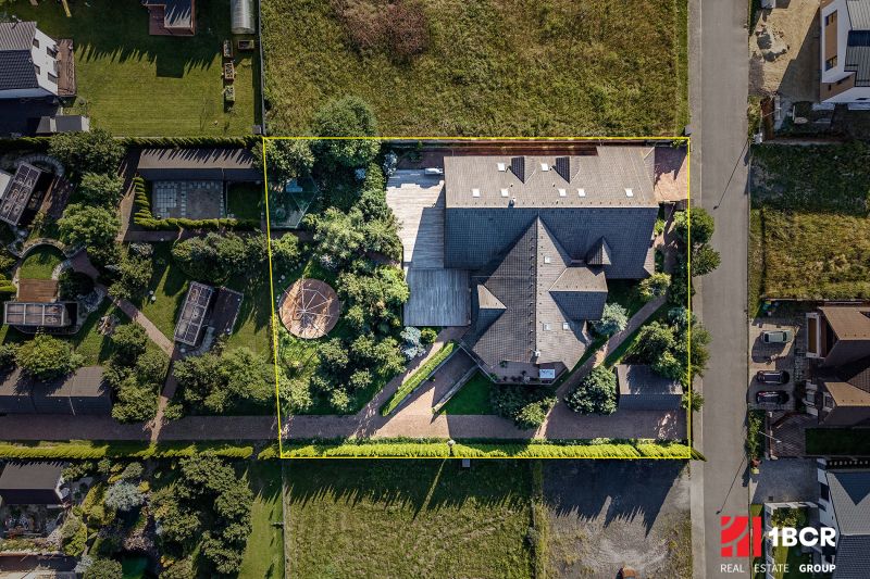 A family house in Veľká Lomnica surrounded by a garden with a gazebo and a driveway.
