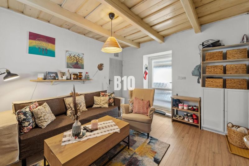 Living room in a family house with wooden decor and comfortable seating.