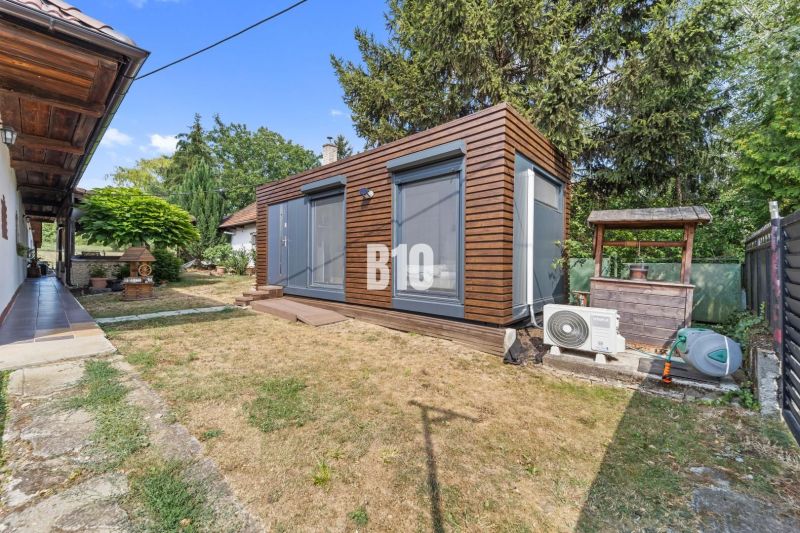 A family house in Podhájska with a garden, wooden gazebo, and air conditioning in the yard.