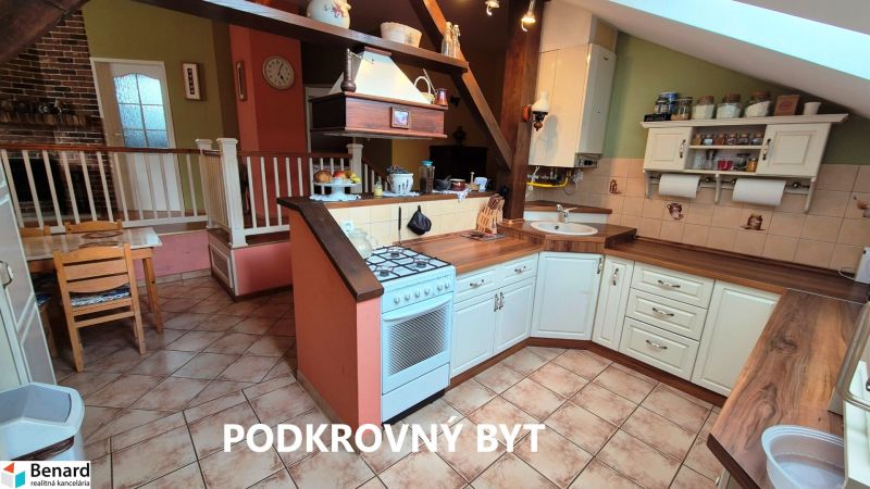 A kitchen in a family house with a countertop, ceramic floor, and dining area.