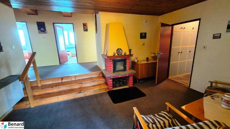 A family house with a fireplace and wooden stairs, a cozy interior with a living room.