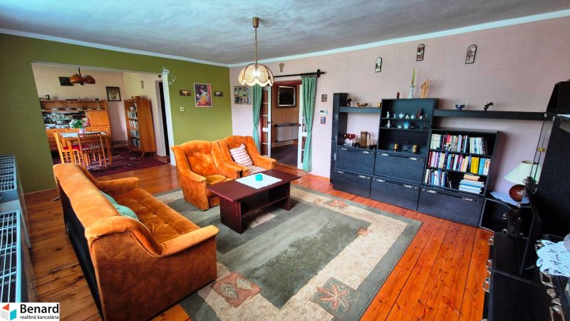 Living room in a family house with retro furniture and a wooden decor floor.