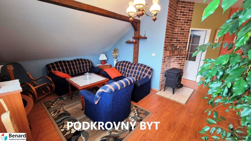 Attic apartment with comfortable seating, brick wall, and wood-decor flooring.