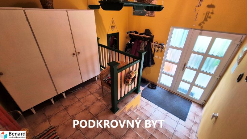 Entrance hall with tiles, wardrobe, and glass doors in a family house.