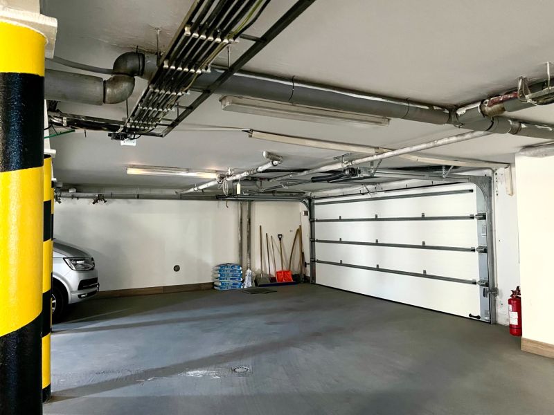 Garage with a car, tools, and a yellow pillar in the business premises of the Office.