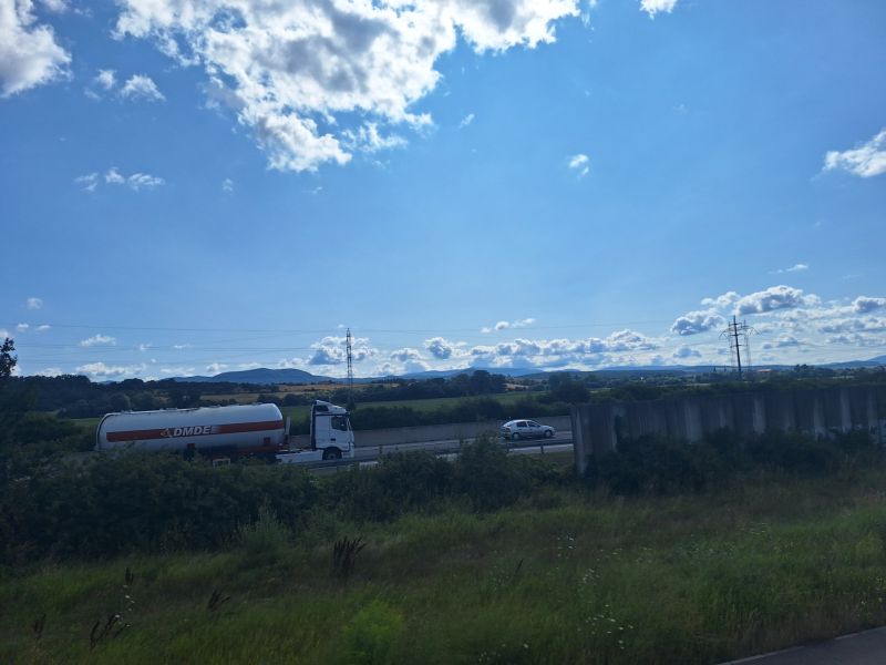 A truck on the highway surrounded by countryside near Ličartovce.