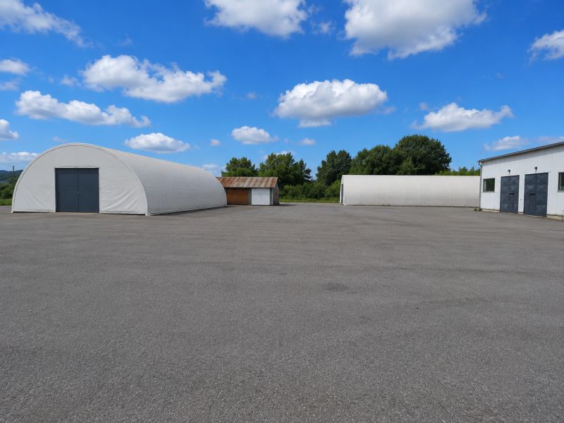 Warehouses and halls in Ličartovce with extensive paved areas and arched buildings.