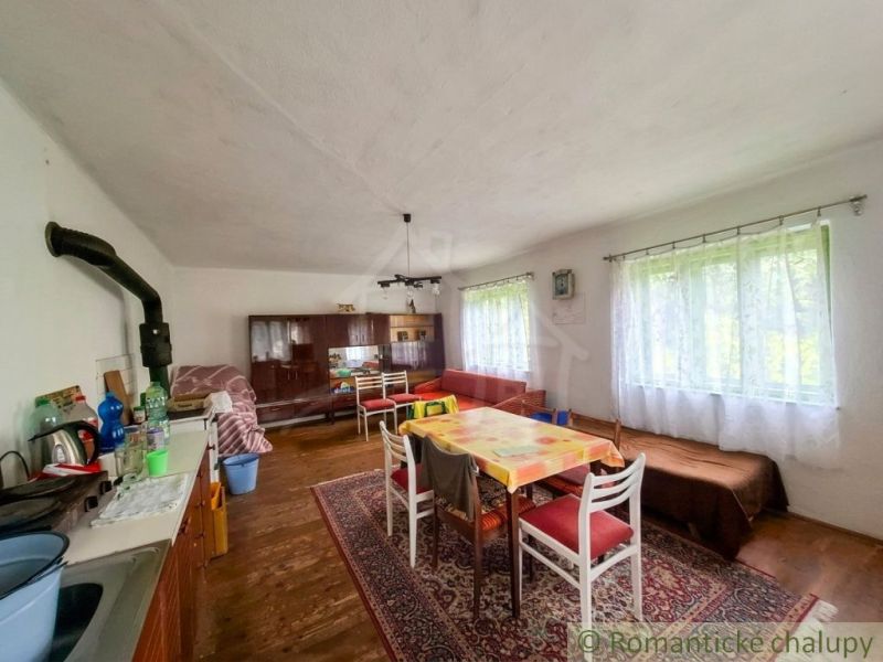 Dining room in a family house with a wooden decor floor and wooden furniture.