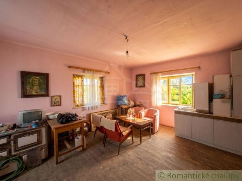 Living room in a family house with a wooden decor floor and retro furniture.