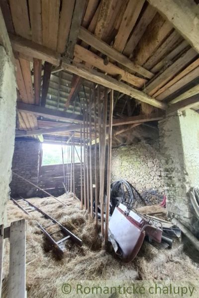 Interior in a family house with piles of hay in Dobroč.