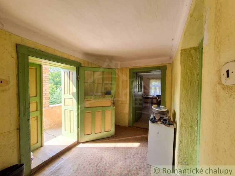 The interior of a family house with green doors and rustic furnishings.