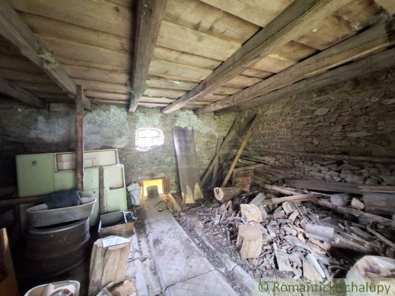 A rustic room in a family house with old tiles and wood.