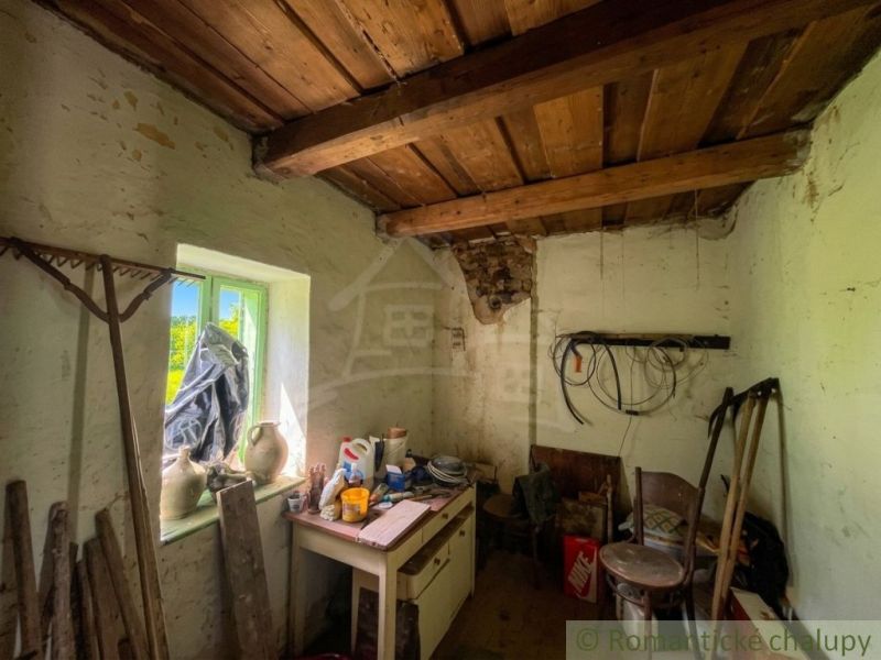 Wooden ceiling and antique tools in the interior of a family house.