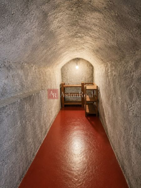 A hallway space with a vaulted ceiling and red floor, part of a 3-room apartment.