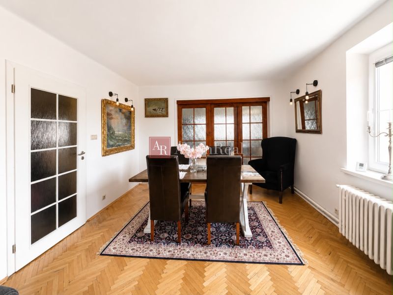 Dining room in a 3-room apartment with a wooden decor floor and decorative elements.