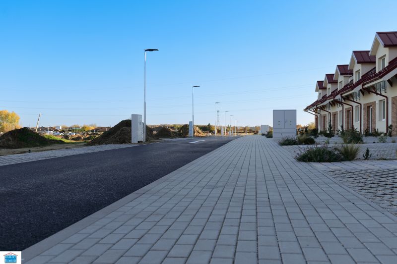 A row of family houses in Andovce, next to the renovated sidewalk and road infrastructure.