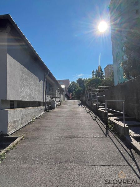 Access road to the garages on Púpavová in Bratislava, Karlova Ves on a sunny day.