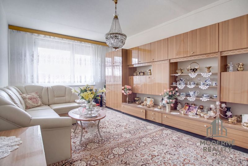 Living room with a sofa set, display cabinet, and carpet in a 4-room apartment.