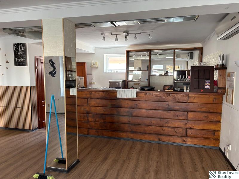A café with a bar counter and a wooden decor floor in commercial premises.