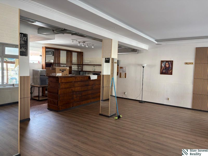 Commercial space with a bar counter and a wooden decor floor.